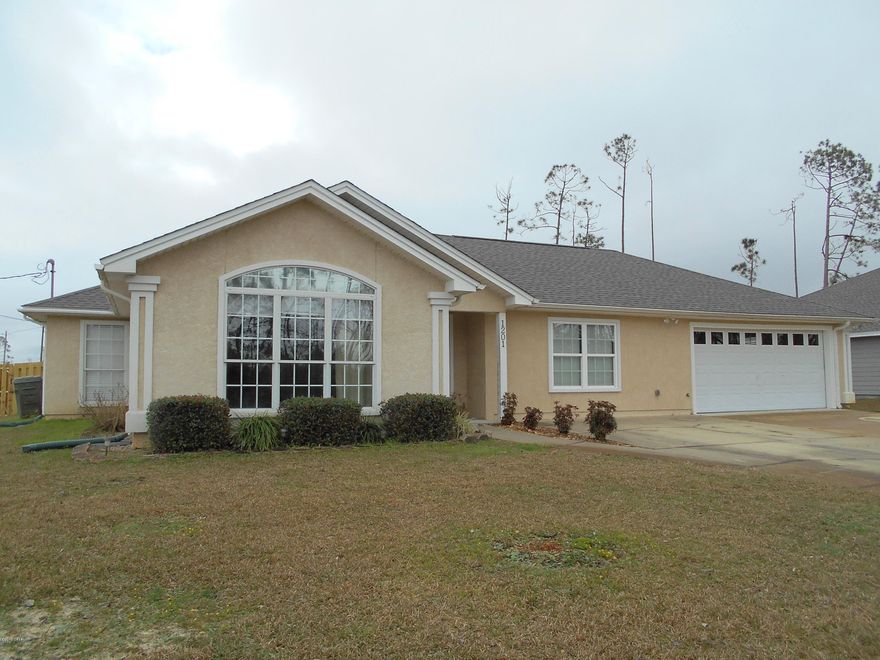 Great new price on this immaculate, move in ready home on a double lot in Lynn Haven. Home had very minor storm damage that was quickly taken of. Home got a new roof, new attic insulation, new paint, new carpet in 2 bedrooms, new garage door, and a new privacy fence. New A/C in 2015 when the home was remodeled, adding the additional bedroom/bonus room, and new garage. The large 4th bedroom is perfect for any bonus room activity if not needed for a bedroom. The large dining room overlooks a very nice back yard, large enough for a pool and patio, gazebo, and storage building. Also, close to several public parks and boat ramp. The ample size garage also has a large separated storage area. Side yard is separately fenced for a pet, and front driveway is 4 cars wide.  Meas. approx.