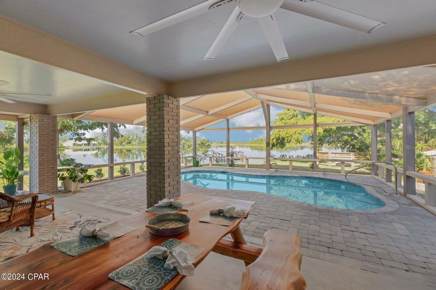 Welcome to your dream home, where serene lakefront living meets modern luxury. This exquisite 3-bedroom, 3-bathroom residence with dual primary suites, boasts an additional office space, perfect for remote work or creative pursuits as well as covered RV parking and detached workshop. 

Step outside and be captivated by your own private screened lanai and inground saltwater pool, offering a refreshing retreat with picturesque lake views. The lakefront firepit is ideal for cozy evenings, entertaining friends, or simply enjoying the tranquility of your surroundings.  Indulge in your own large new custom red cedar sauna. Its spacious interior offers a luxurious spa-like retreat right at home, perfect for unwinding after a day at work or on the lake. 

This home offers a truly unique living experience with its stunning location on the end of a peninsula. Enjoy breathtaking sunrise views right from your front door each morning and relax with gorgeous sunsets in your backyard each evening. The private dock is perfect for boating and fishing, allowing you to catch bass and bream right from your own property. Situated on a private street, this expansive lot provides a lakeside paradise where both children and adults can explore and unwind.

Inside, the home has been thoughtfully updated with new plumbing fixtures, HVAC, and kitchen appliances, ensuring comfort and convenience. The generous detached workshop is perfect for all your hobbies, projects, and storage needs. With ample space to accommodate most RVs, it offers versatility and convenience, making it an ideal addition for those who need extra room for their interests or equipment.

Experience the perfect blend of modern amenities and natural beauty in this exceptional lakefront property. Your waterfront paradise awaits!

See Documents for List of Recent Updates and Features.