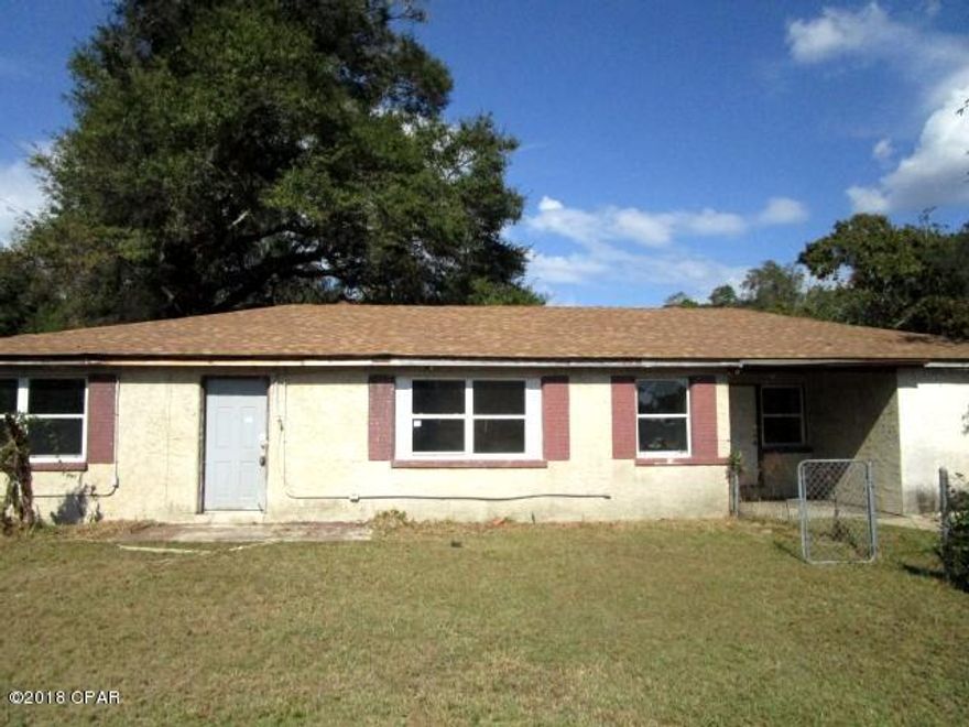 This property is on the high-traffic Business Hwy. 98 with good exposure for a small business. Just minutes from Tyndall Air Force Base, this home features a large living room, three or four bedrooms and two full baths, as an addition to the home added a bedroom, full bath and utility/storage room. The property is being sold in its AS IS condition. Note: The property does not include the entire fenced-in- backyard, as 36'x 100' are part of a separate parcel and not included in this sale.