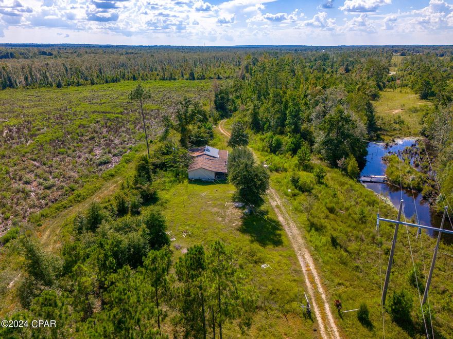 This is your chance to purchase beautiful, secluded acreage in Alford, FL just minutes away from Compass Lakes. There is a home on site for a potential remodel but this property is listed at land value so there is a lot of upside to the right person. Do not miss your chance to own this peaceful property in Alford.