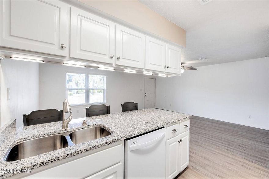 Meticulously well kept and upgraded throughout with new water/moisture resistant LVP Flooring (NO CARPET). Matching, Upgraded Kitchen and Bathrooms, including Vanities, Granite Countertops, Cabinets and New Fixtures. Freshly painted, with all new matching ceiling fans, recessed lights and Brand New Water Heater! Newer appliances in Kitchen, including Granite Countertops, additional 'high to low' LED lighting added underneath Custom Cabinets, right above the new Deep Stainless Steal, Double Basin Kitchen Sink, all equipped with newly installed 'main GFCI in Kitchen' & 'GFI circuit outlets in Bathrooms' for added protection and safety to All Appliances, Bathrooms and breaker box circuit. New Roofs, Storm Grade Windows and Exterior Paint completed 2020-2021. Same Owner since Built in 1985!