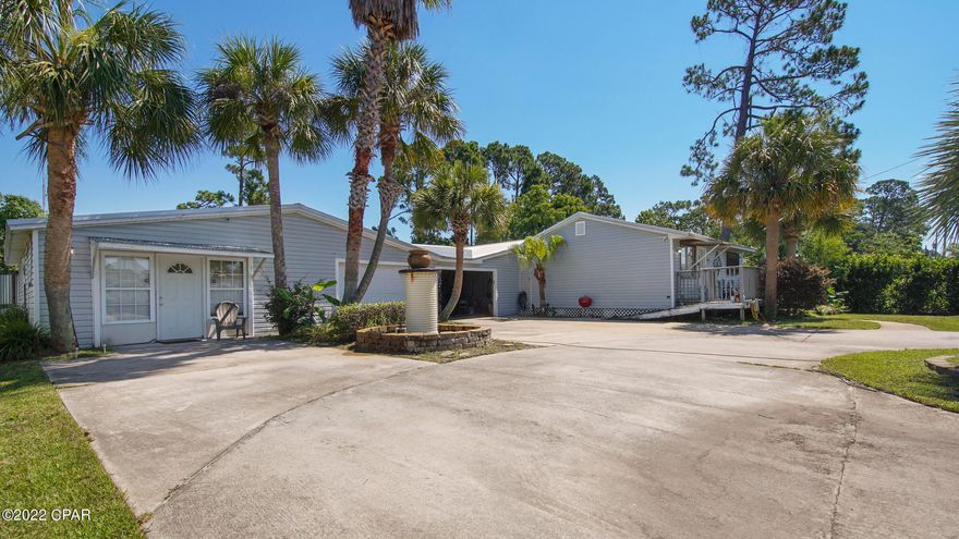 TREMENDOUS BEACH INVESTMENT OPPORTUNITY! This large parcel is almost 1/2 an acre of valuable income producing property. So many options and no restrictions on rentals! The main house (aprox 1550 sq feet)  is a well maintained 3/2 with an open living plan and 2 car garage. An attached 1/1 bath apartment is perfect for short term rentals! The outside includes a new metal roof , oversized 2 car garage and a well and sprinkler system for  the nicely landscaped yard . ALSO included is the lot at the NE corner of Laurie and Terrell that has a 1984 mobile home with a long term tenant.All these units could be long or short term rentals with a tremendous potential for income. The mobile home could be removed for new construction. The sky's the limit for the smart investor!