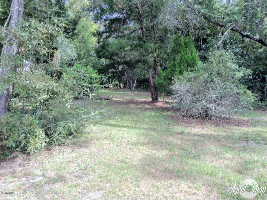 These three Lynn Haven residential city lots  would be the ideal location to build your dream home in the heart of Lynn Haven; or to subdivide and build three homes!  There is an older home in the middle of the two lots - there is some salvageable wood, etc. in the structure.  Information is approximate - if important to buyer please measure.