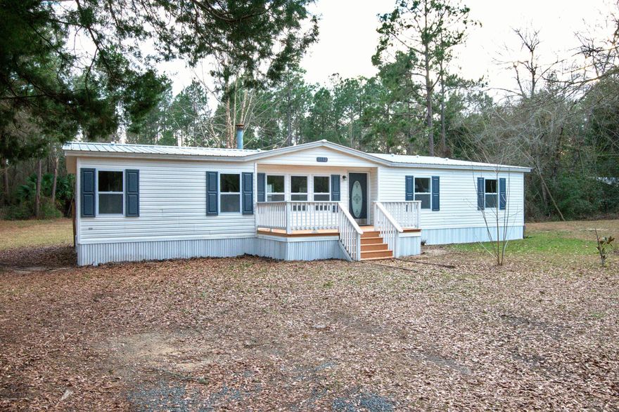 WOW is an understatement for this remodeled home nestled away on almost 1 acre of land near town. Open and spacious floor plan with split bedrooms and wood burning fireplace.  If you love to cook-you will have plenty of room in this kitchen. Lots of cabinets, counter space and all new stainless steel appliances and sink.  Master bath features double vanity, garden tub and separate shower. Large walk in closet in master bedroom. All new flooring throughout, new doors, new door knobs, new hardware, new HVAC system, new water heater, new faucets, new toilets new double pane windows, new metal roof and all water supply lines (except tub in master bath) replaced with pex pipe. Septic serviced and new pump and alarm installed on system. Nice large front and back porches.