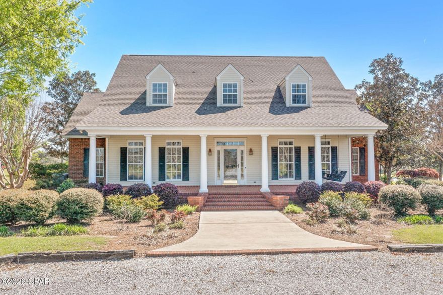 Nestled amongst the mature pecan trees, this custom-built home offers a peaceful country setting with classic Southern charm. A gated entrance leads you down a gravel drive to a stately home where timeless design meets serene surroundings. Step inside to a grand foyer with soaring ceilings that immediately set the tone. To the right, a formal dining room provides an elegant space for gatherings and flows seamlessly into the kitchen, offering both function and convenience. Straight ahead, the living room serves as a warm and inviting focal point, complete with a fireplace and custom built-ins that add character and charm. The layout offers a natural flow while still maintaining distinct living spaces.  The main level is set up for everyday living with a spacious primary suite featuring dual vanities, a separate shower, and a classic clawfoot tub. There's also a convenient half bath for guests, plus an oversized laundry room with a sink and plenty of storage. A separate study on the main floor gives you flexibility and could easily be used as a fourth bedroom or home office. Upstairs offers two additional bedrooms, a full bath, and a flexible space perfect for extra living room or a hangout area. Outside, enjoy a covered porch and patio overlooking a beautiful saltwater pool, outdoor shower and an enclosed barn with 2 roll-up doors, ideal for a workshop or storage. The rear of the property is fenced for livestock and includes a pond tucked into the back corner, adding to the property's charm and usability. Located just north of Bonifay this property is a direct route to the white sandy beaches along the Gulf Coast.