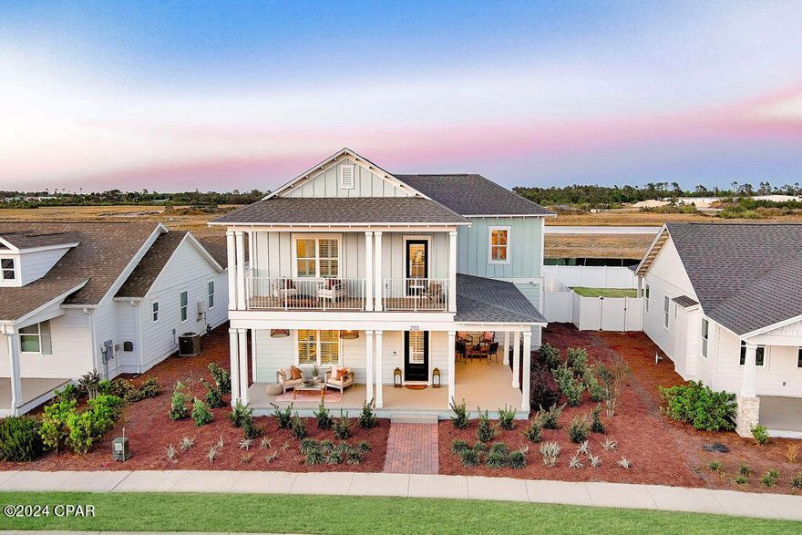 This spacious 5-bedroom home offers plenty of living space & room to entertain with an expansive Great Room that flows into an open kitchen, separate dining area, + covered lanai with fireplace and cedar mantle! The first floor includes a primary bedroom suite plus an added bedroom.The second floor features a loft area that can be used for a media room/ office space plus 3 extra bedrooms! Thoughtfully designed with stylish finishes such as custom light fixtures throughout, quartz countertops, decorative wood accents, stainless appliances with gas range + wood vent hood, built-in microwave, and kitchen farmhouse sink. Walking distance to the newly opened community pool. Sweet Bay is one of the fastest growing communities in Panama City. Centrally located, this community is surrounded by North Bay for waterfront access for all homeowners. You'll enjoy kayaking, canoeing, paddle boarding, fishing and walks on the beach to take in the best sunsets in Panama City. Carefully designed parks throughout the community create an enjoyable retreat-like feel and neighbors enjoy two swimming pools, basketball court, community walking & jogging trails, and an amphitheater. The community is golf cart friendly and pet friendly! A renowned charter school, University Academy, is at the heart of the community and is enjoyed by many residents.