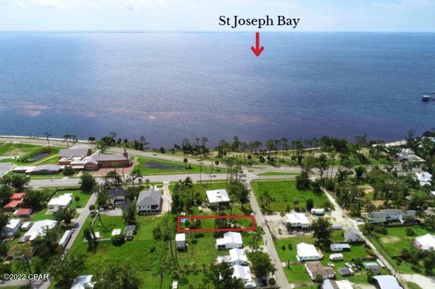 APPEALING BAY VIEW LOT MINUTES FROM DOWNTOWN PORT ST JOE! This parcel was recently surveyed & has been subdivided to create this .20 acre lot. Make plans to build your dream home in this beautiful setting surrounded by mature trees & native Florida foliage. Sunsets over pristine St Joseph Bay are magical & create a one-of-a-kind watercolor painting. Teeming with wildlife, this area of the Forgotten Coast attracts boating & fishing activities from locals & tourists alike. Preparations are underway for a state of the art dry storage facility to hold an impressive 252 boats! Less than a mile from this property is the community boat ramp for Gulf access. Golf cart transportation is all you need to visit locally owned businesses & shops for fresh seafood & live entertainment. Call for a showing