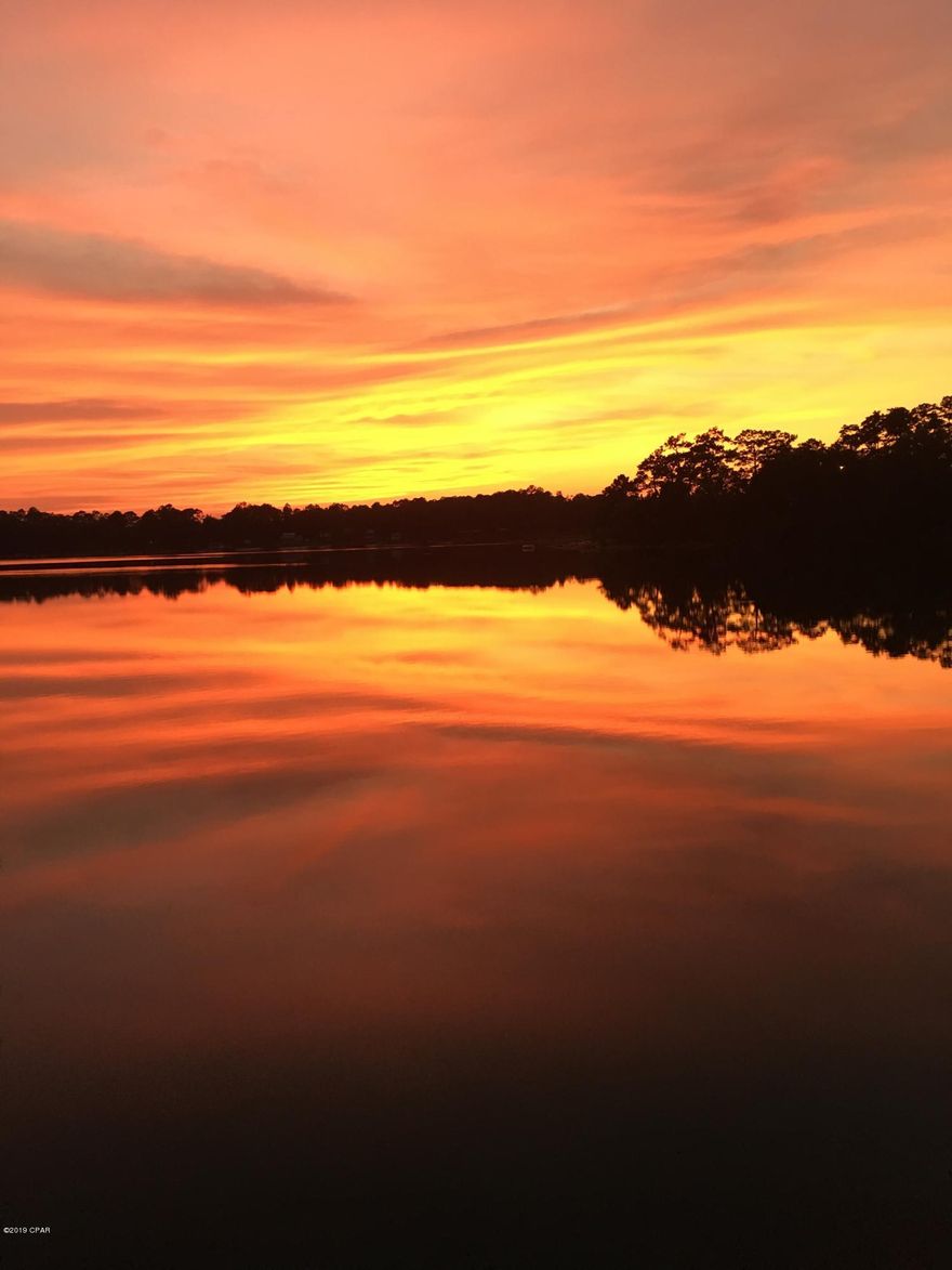 Lake home with spectacular view on east side of lake.  Enjoy the majestic sunsets from the vaulted, screened in back porch.  In winter enjoy the same view with a fire from the wood burning fireplace in living room.  There is a nice walkway down to the good sized deck.  Master bedroom has windows that allow you to view the lake year round.  Come get your home on the private spring-fed Lake Mystic.