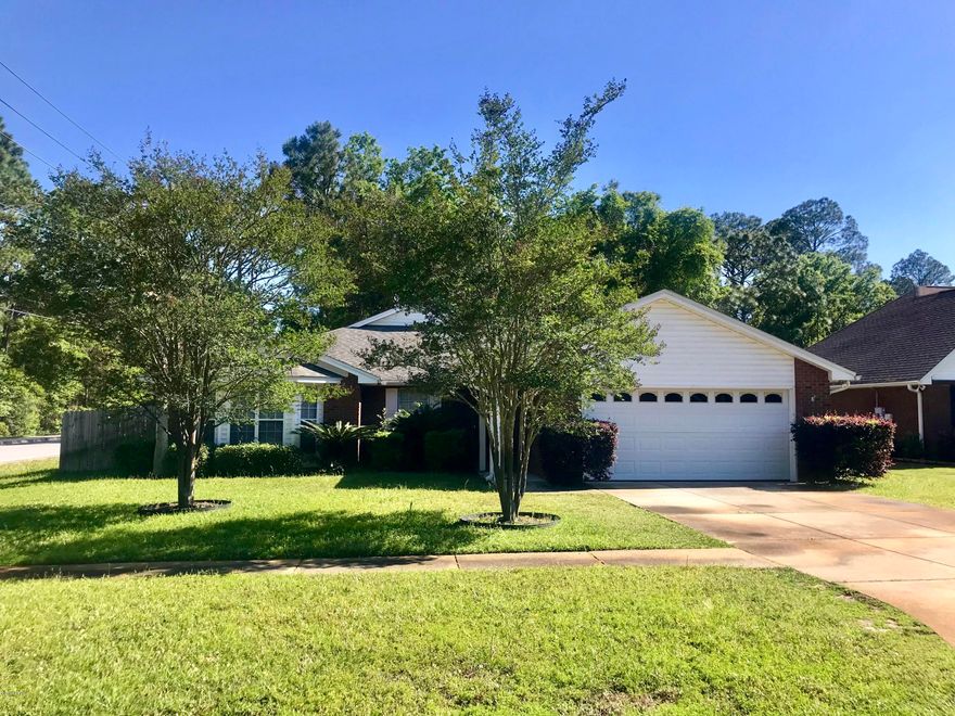 Lovely brick home located on a large corner lot in the much desirable area of Lynn Haven. This split floor plan home features 3 bedrooms, 2 full baths, living room fireplace, swimming pool, spacious screened in porch, & work area in the garage.