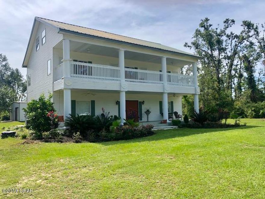 ''PRICE REDUCED''    Stunning 3 story home in beautiful Compass Lake Hills.  The lodge and restaurant  are within just a short walk.  Home has exquisite features that include 4 bedrooms with 3 full baths and 2 half baths. 3 of the bedrooms are suites with their own bathrooms and kitchenettes. It has plantation shutters. The kitchen is a dream with stainless appliances, a convection oven, a farmhouse kitchen sink, a butlers pantry plus 2 regular pantries.The front porch extends all across the front and the 2nd floor has a balcony that also extends across the entire front and one side.  A 1600 sq.ft. shop is included.  The house is built with all steel frame.  One of the suites on the 2nd floor has a den and office.