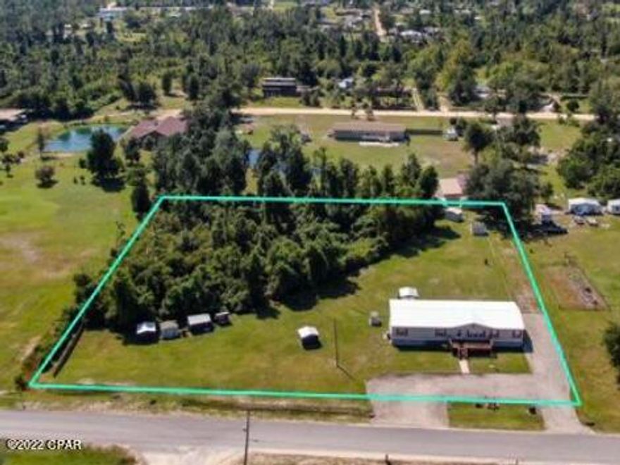 ***CURRENTLY UNDER CONTRACT, SELLER WILL CONSIDER BACK UP OFFERS*** 4BD, 3BA country home on 2.07 acres. 15 minutes from Panama City and 25 minutes from Panama City Beach** Updates and extras include: 2019 metal roof, Sept 2022 A/C(with transferable warranty), new vinyl plank flooring and carpet, under cabinet kitchen lighting, ceiling fans, 4 outside storage units(1 heated and cooled)3 custom chicken coops(1 heated and cooled), crawl space is lined and lighted, under sink infiltration system and water softener(both owned), well, TV antenna with equipment, front and back decks and a covered gazebo with electricity. Septic system was maintained regularly with February 2022 being the most recent maintenance. All info is approx and should be verified by buyers if important
