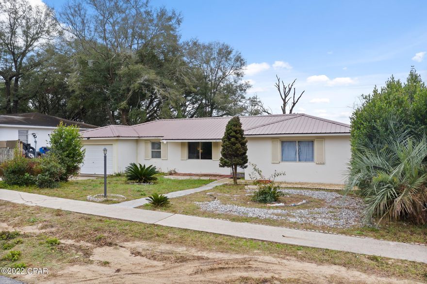 Two Bedroom One Bath home in Sunny Hills on the Watering Pond. One Car garage. Open floor plan for living and dining area. Home has terrazo floors and so much potential.