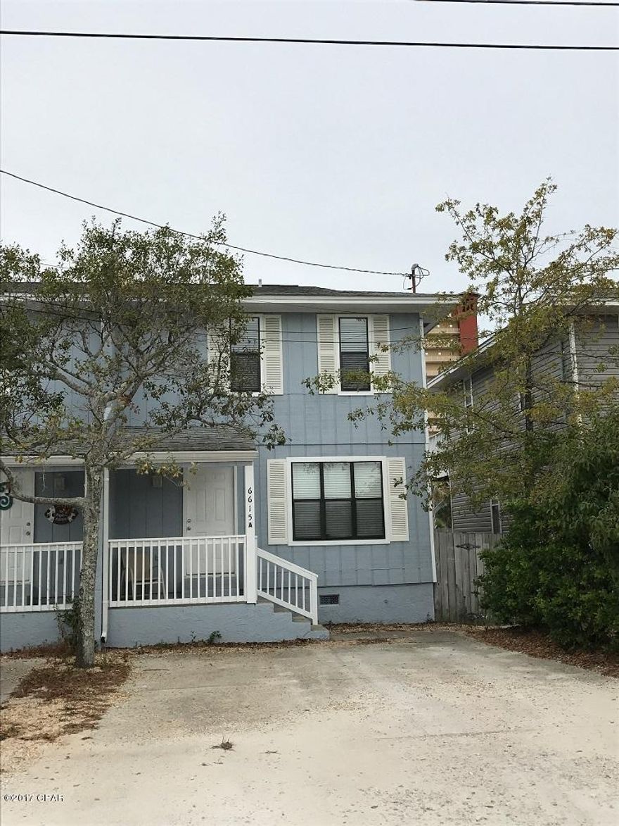 Just a short walk to the beach for this 3 bedroom 1.5 bath town home in the Thomas Drive area. This home feature tile floors downstairs, open patio down stairs, and an open deck off of the 3rd bedroom.
