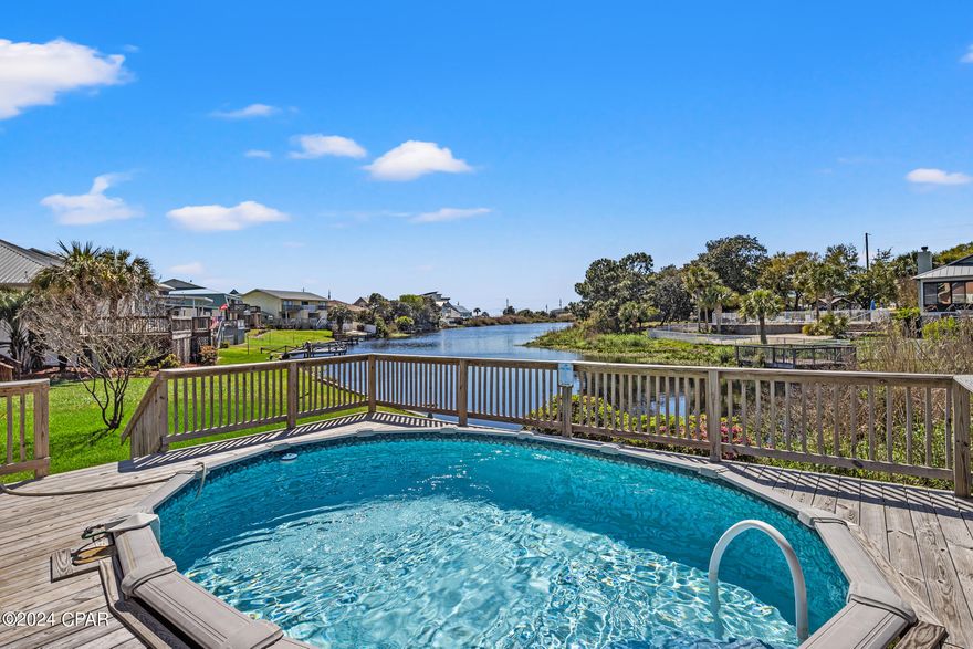 Lake-Front, Pool, Walking Distance to the Beach, No HOA, Fresh 2024 Updates, Fully Furnished, Stunning Views & Amazing ROI! Escape to paradise with this stunning lakefront property nestled in a tranquil setting, just a leisurely stroll away from the sun-kissed shores of the beach. Offering the perfect blend of natural beauty and coastal charm, this home is the ultimate retreat for those seeking the perfect investment beach home with above average ROI 80k+!, 2nd home or primary residence. You will love the open concept with an abundance of natural light and amazing views. New updates like, granite counter tops in the kitchen and all baths, custom soft-close cabinets, luxury vinyl plank flooring, fresh interior & exterior paint, new deck with a phenomenal view and more! Large master bedroom with double vanity, walk-in closet, a separate tub and shower, a private new balcony with a gorgeous view of the lake and gulf of Mexico. 2 car garage and 4 car driveway. This is a Rare Find on West End of Panama City Beach. Call me TODAY for a private tour! Video tour available.