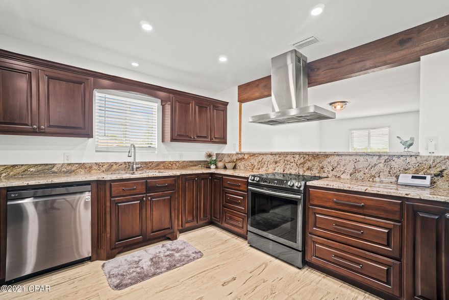 Move-In Ready Home has NEW metal roof, HVAC w/ air ducts, electrical, insulation, water heater, tempered glass windows, stainless steel appliances, doors, fixtures and tile flooring throughout. Kitchen has gorgeous granite countertop w/ custom soft close all wooden cabinets. Remodeled bathrooms have walk-in showers and premium glass doors. Mbath has safety grab bars great for elderly or handicapped. Oversized laundry room/mudroom right off the garage w/ butcher board countertop cabinets and a sink! Workshop that can be turned into a den, exercise/game room, office, or guest suite. Workshop  has electricity, is fully insulated and a window! Well sprinkler system in front yard. Screened in porch and fully fenced backyard w/ multiple entries. Close to Tyndall AFB! Don't miss your opportunity!