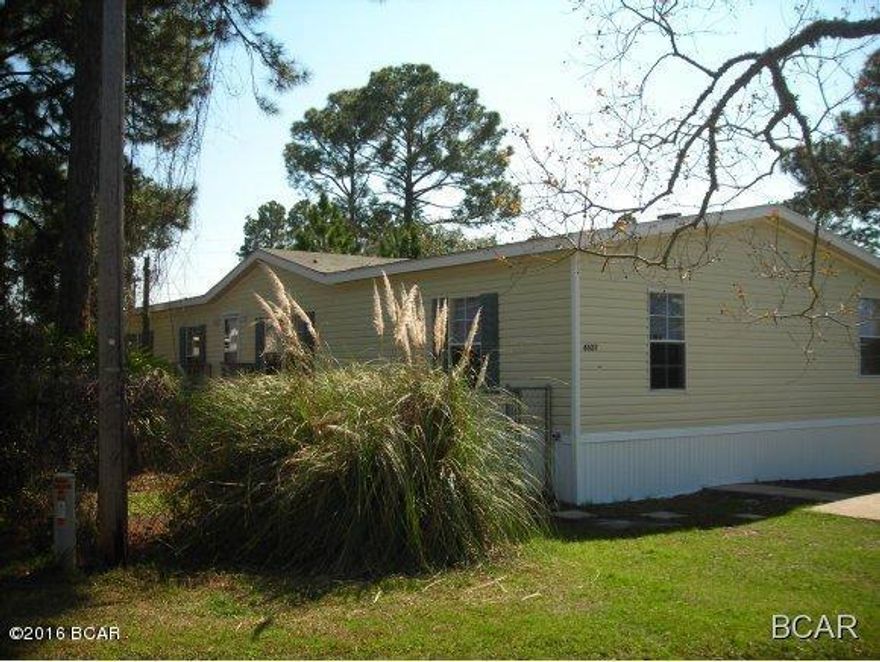 MOBILE HOME IN POPULAR BAY SIDE SUBDIVISION, ONLY A SHORT WALK TO THE MARINA. THIS WOULD MAKE AN EXCELLANT VACATION OR RENTAL PROPERTY. This home has a SPACIOUS and OPEN FLOOR PLAN. The KITCHEN, WITH CENTER ISLAND, opens into both the FAMILY ROOM with FIREPLACE and a SEPARATE DINING area. The large MASTER SUITE has a WALK-IN CLOSET, and the MASTER BATH HAS GARDEN TUB, DOUBLE-SINK VANITY, and separate SHOWER. The lot is FENCED with both chain-link and PRIVACY FENCING. Roof 2014,Heat Pump new, Water heater new.
