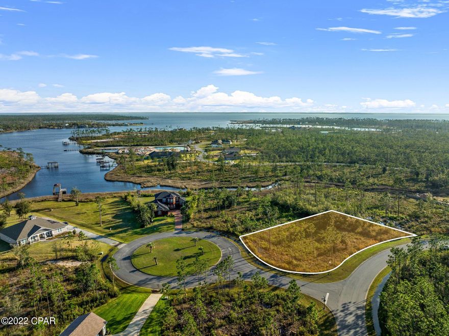 Over 1/2 an acre in a gated, waterfront community, you don't want to miss this opportunity. This lot is situated on the corner of a cul-de-sac and is the perfect place to build your forever home. The community amenities include a pool, a boat launch and dock, and a gated boat/RV storage area. Tyndall Air Force base is approximately 10 miles away and just 30 minutes either way to white sandy beaches.