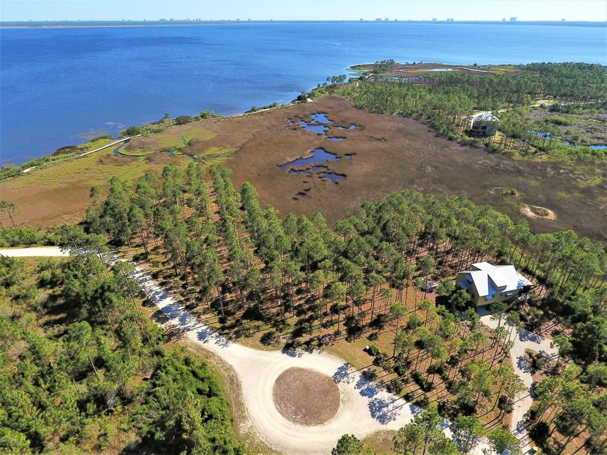 7607 Big Salt Marsh Lane, Rivercamps on Crooked Creek, a gated community with a waterfront lot in the midst of a 1500 acre woodlands preserve. Located minutes from the NWFL INT Airport, close to Panama City Beach, 30A, Pier Park and the Gulf of Mexico Emerald Green Waters and Sugar White Sand, surrounded by a wonderland all the way around! Amenities include, community pool, conference center complete with kitchen, library with internet access, workout center, screened outdoor meeting area, pool, spa, table tennis room, boat docks as well as the activities center w/ canoes, kayaks, bicycles. Come Visit Old Florida on Big Saltmarsh Lane today!