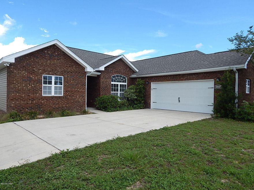 2007 Brick 3 bed 2 bath home on large corner lot in Popular Southport newer subdivision. This subdivision in convenient to shopping, schools, and all that Lynn Haven has to offer. Reasonable commute to NSA (Navy Base) and Tyndall AFB. This home had minor HM damage and sports a new roof, all fresh interior paint, and new carpets in the bedrooms. This is a light and bright,  great open split floor plan with raised ceilings and Tile floors in all the ''wet area's'' ie kitchen, baths, laundry. The LR/DR is also title floors. The master is spacious with a extra large walk in closet, double vanity sinks, and lots of light,. This home has brick front facade with vinyl siding for easy care. This home is move in ready. Come take a look.