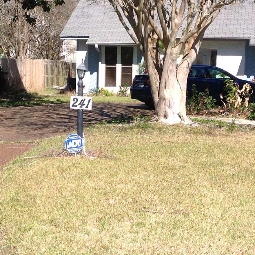 Contemporary Florida home featuring a large OPEN FLOOR plan.  This 3 bedroom 2.5 bath home offers the popular split bedroom plan.  The spacious kitchen offers new countertops with counter seating.  The cabinets have been refaced and new hardware was installed.  The living dining area has a gas fireplace and opens onto an open deck and level fenced backyard. The current owner was in the process of adding a pool, however, it was never completed so add your personal touches to make this backyard a tropical paradise!  This home needs some work but has tons of potential.  Close to the beach, area attractions, great restaurants and shopping.  Schedule a showing before it's gone.