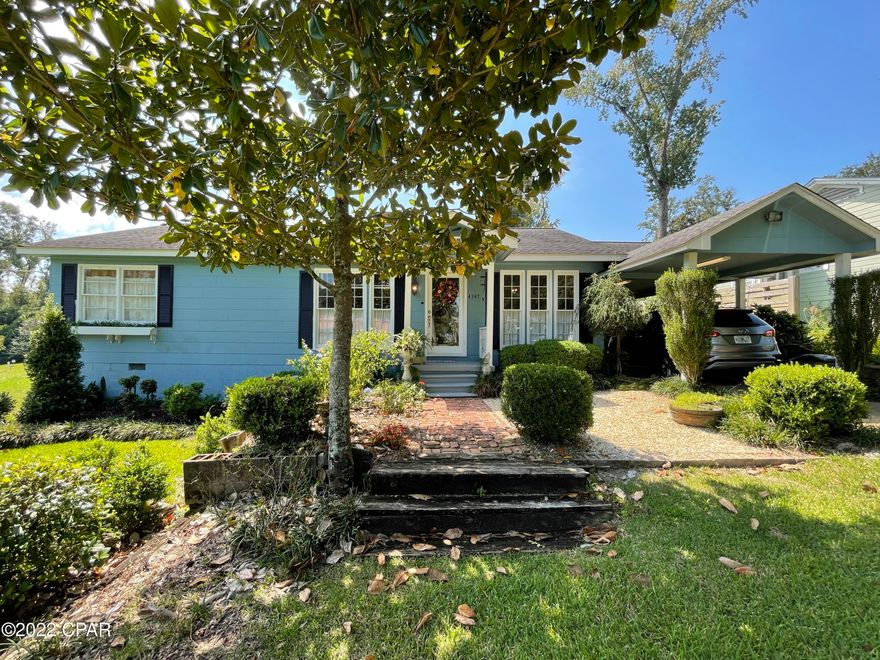 Southern Charm! Beautiful 3 bedroom, 3 full bathroom Florida cottage in the heart of downtown Marianna. This home is situated on a quaint street in a desirable neighborhood in Marianna. The home is perfectly landscaped with an attached carport, garden with workshop in the backyard, and located on a deep lot that stretches back giving you a generous backyard. The home has a formal living room that is open to the dining room with stained glass windows, the kitchen has a large pantry, there is a den, two bedrooms with a full bathroom between with a double vanity and tiled shower. There is a sunroom/office space with another full bathroom, and laundry room that opens to the open back deck. This also leads you to the expansive master bedroom with newly remodeled en suite bathroom with vanity. The roof is approximately 9-10 years old; HVAC 5-6 years old; water heater replaced in 2016; gas fireplace; previous survey done by Latitude Surveying available; lot has underground fence that owner will leave with collars for a the pet lover; the shed has a window unit making it perfect for hobbies!