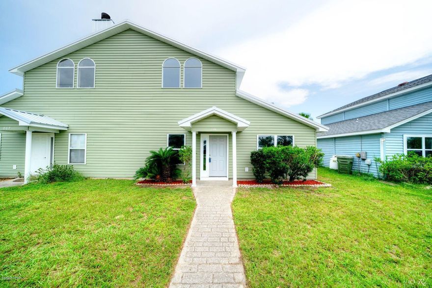 Beautifully remodeled 3 bed, 2 bath townhouse in the heart of Lynn Haven. This home has been upgraded with many updates including a new metal roof, fresh paint, modern ceilings fans,  new carpet, LVP flooring, and more. This home is welcoming with vaulted ceilings, creating a wide open feel. The living room is adorned with large windows to allow for plenty of natural lighting to illuminate the room and opens up to the eat-in kitchen. The kitchen is equipped with stainless appliances, beautiful wood-look counters, plenty of cabinets, and a breakfast bar. The master bedroom is the only room upstairs and features a private en suite, offering plenty of peace and privacy. The master bathroom has a grand, updated vanity, a private toilet and shower room, and a linen closet. The master bedroom overlooks the backyard and features a walk-in closet with shelving. The two guest bedrooms are located on the main floor of the home and both closets feature built-in shelving. The guest bedrooms share a full bathroom featuring a shower/tub combo, an updated vanity, and modern ship lap. There is a utility room off the kitchen and it leads to the screened back patio. The back patio is the perfect spot to relax and bask in the tranquility of your peaceful backyard. This home is located near schools, parks, restaurants, shopping, and more.