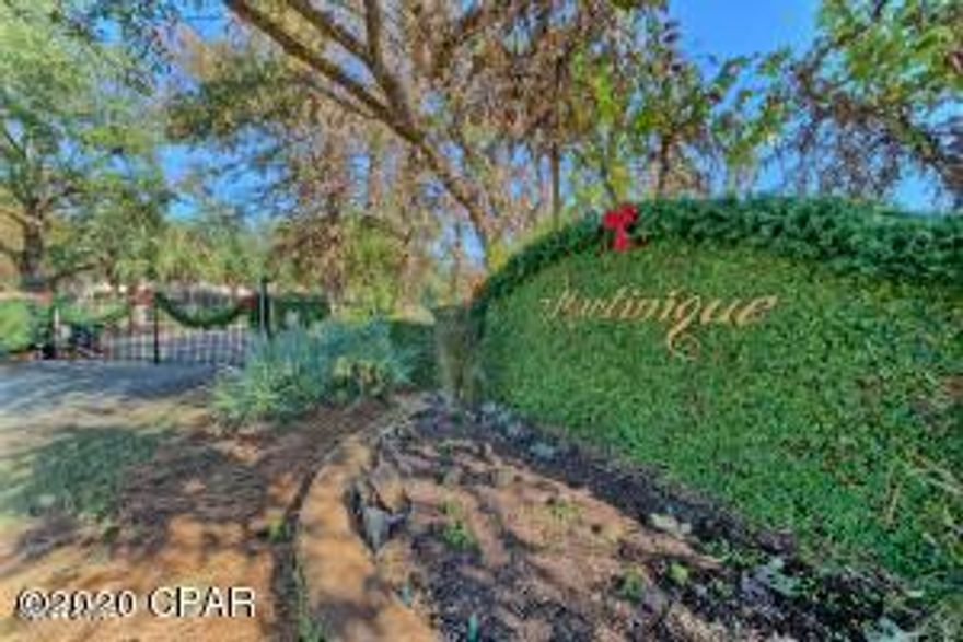 Large pond front lot in the desirable gated community of Martinique. Lot 48 is located on a quiet street in the back of Martinique. Martinique offers custom built homes with old Florida style architecture. The neighborhood features a pool, ponds, walking trails, playground and basketball court. It is also with in walking distance of a marina and several restaurants on the east end of Panama City Beach.