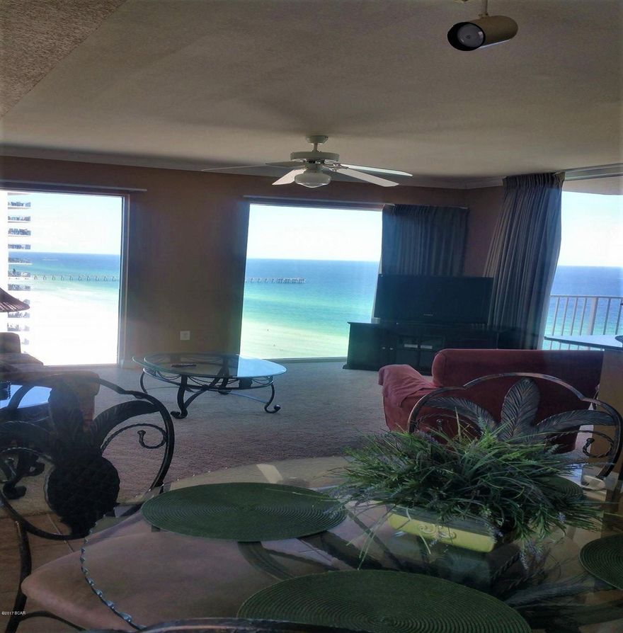 Extraordinary panoramic view from this private corner unit. Gorgeous gulf view and street view; watch the beach excitement from the comfort of your own living room as you can see all the way to Pier Park and West Bay from this unit! Enjoy cocktails from your private balcony overlooking the Gulf of Mexico! Spacious living room, full kitchen with granite counters. Master bedroom with bunk beds in the hall. Unit being sold fully furnished with  sleeper sofa and has been a great rental unit. There is a laundry closet with a stack washer/dryer unit. There is an exterior owner's storage closet that does not come standard with most units. Tidewater is near Pier Park and Frank Brown Park, the amenities include gulf front gym,hot tubs, 2 outdoor pools with 1 indoor heated pool, steam rooms, restaurant, poolside Tiki bar,covered parking, and owners lounge. This unique unit won't  last long!   Buyer to verify all fees and information.