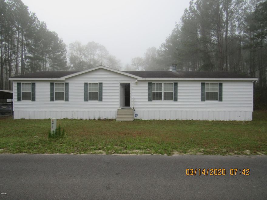 Location is Key with this move in ready property. You get the peace and quiet of country living and less than an hour from The World's Most Beautiful Beaches, Tyndall Air Force Base, Famous Pier Park Shopping, Camping, Kayaking, Canoeing, and some of the best Fishing on the planet Saltwater & Freshwater. Visit some of the worlds most pristine natural cold water springs nearby. This 1 1/2 acre property is fenced in the back and comes with a spacious outbuilding and carport. It was used as a getaway home so it has been kept in great shape. Large bedrooms, double vanities, walk-in closets, breakfast bar, large back deck.  NOW is the time to come and see this one for yourself. Call today for your private tour.