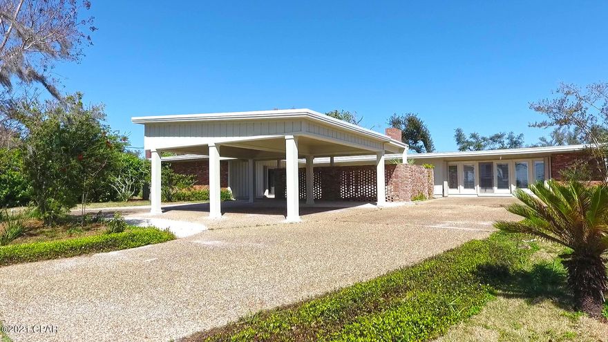 From the moment you turn down Bunkers Cove Road and wind along the bay, you realize you have found a hidden treasure. This sprawling 4-bedroom 3 bath Cove home is located across from Watson Bayou/St. Andrews Bay. As you enter the home you are welcomed with a large open great room with hardwood floors and oversized sliding patio doors. Another focal point is the large wood burning fireplace with cabinets on each side to store all of your media and electronics. The vaulted ceiling features wood beams and transom windows between each beam which allows natural light to flow through. The kitchen is a chef's dream with granite countertops which are complimented with a gas stove, kitchen island, side by side refrigerator and an extra-large walk-in pantry. There is also a wet bar complete with a sink, wine cooler and refrigerator. Off the kitchen is a huge family room with wood plantation blinds that allows an abundance of light and a pass-through niche to the kitchen. The dining room features wood beams, natural light flow from large windows and is located off of the kitchen with access from the great room. The master bath is truly a tranquil retreat! In it, you find a large soaking tub, separate oversized walk-in shower, double vanity with his and her sinks, separate makeup area, and a huge walk-in closet. The home offers 3 additional comfortable bedrooms and 2 full size baths. This home is close to schools, the St. Andrew Bay Yacht Club boat launch and just a short golf cart ride to downtown Panama City shopping and restaurants.

All sizes, ages and measurements are approximate; buyer to verify if important.