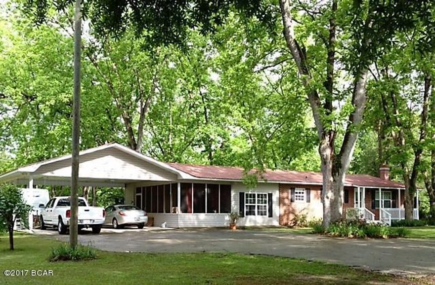 From the canopied trees and large outbuildings, the exterior of the home is SO inviting! Step inside this brick home and be amazed at the beautiful hardwood floors.  The kitchen is open to both the dining and living areas.  And the master suite features an oversized closet and sitting area! PLUS the location of this home cannot be beat...The pictures do NOT do this home justice.