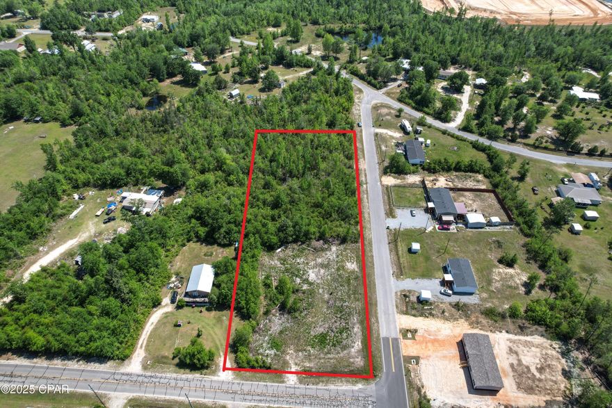 FUTURE HOMESTEAD! 100% FINANCING ELIGIBLE THROUGH USDA! This partially cleared nearly 1.5 acre parcel is ready for a new owner looking for a quiet country setting with a short commute to town. Paved roads on two side and no flood zone. This corner lot is easily accessible from John Pitts Road or Bayou George Drive and access to the 231 corridor. Zoned Bay County R-2 so bring your livestock and poultry and create your own paradise today!  Survey available in Documents.