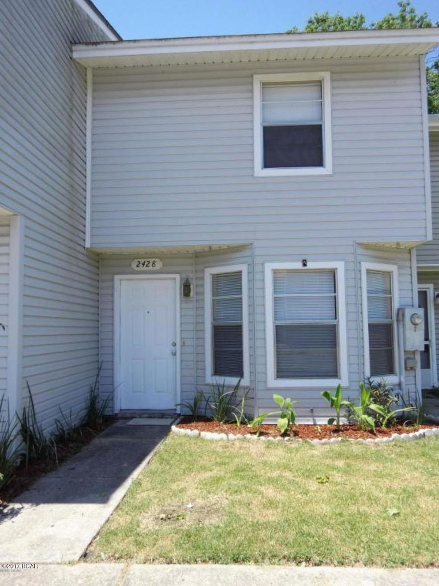 Recently updated with new carpet and paint, this centrally located townhouse is convenient to shopping, restaurants and schools.  Living area has a quaint bay window, and is open to the kitchen.  A handy half bath is tucked away under the stairs.   Washer dryer hookups are ready for your appliances.  Just off the kitchen is the screened back patio, with extra storage room overlooking a privacy fenced back yard.