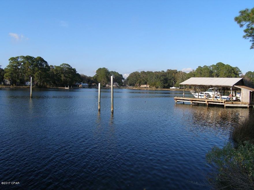 Unbelievable Deep Waterfront Opportunity. 150' deep water dock. Minutes from Tyndall and about 15 minutes to the Gulf. This has been home to 65' sailboat for many years. This property is a golden opportunity to get a magnificent waterfront home for a bargain price. Home is 80% remodeled. Kitchen and baths are waiting for new owner but a lot of the work has been done inside.. Fantastic lot, large storage shed with overhang. 3 finished bedrooms and 2 baths, one original and one waiting to be remodeled. Fantastic finished Florida Room, finished living room and finished office area, and great back porch, Huge Yard, carport, oversized lot. Unfinished garage. Metal roof. Lots of potential.   Located in the desirable Donalson Point area this is a great buy for a commercial type dock on the water.