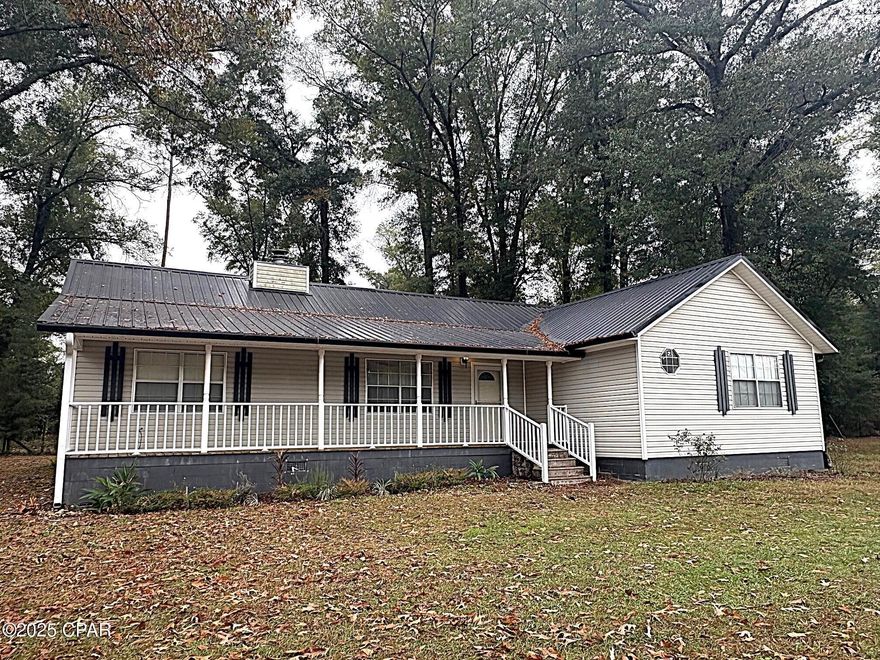 Sitting on 4.58 ACRES is this nive 3BR/2B home, 1842 square foot with a fireplace and split bedroom plan. The metal roof is only about 3 years replaced. The home has 5'6 X 35 rocking chair front porch and looks out over the acerage and on the rear of the home is a bigscren porch and open deck for outdoor enjoyment. Once inside the home the large family room has a wood burning fireplace, the split bedroom plan allowing privacy. One bedroom has arched entrances to a spacious sitting area/office/nursery and full bath while the master suite has a private bath with a claw foot tub.
The acerage is mostly cleared and has  scuppernong grape vines, and pear tree. There is a fine chicken coop that has concrete floor and concrete block house, check out the pictures, and also there is an out building but is in need of repair, 
This is a nice home, in the country so bring the chickens and enjoy peacefull living.