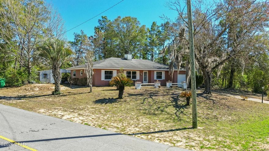 Peaceful Wooded Retreat with Workshop in Sunny Hills, $5,000 Buyer Credit! Embrace the tranquility of Florida living in the established golf course community of Sunny Hills! Perched high on a private, wooded 1/3-acre corner lot, this 3-bedroom, 2-bathroom home offers 1,434 sq. ft. of comfortable living space surrounded by nature. Step inside to a highly functional, easy-to-maintain interior featuring durable Luxury Vinyl Plank and tile flooring throughout, absolutely zero carpet! The layout flows seamlessly out to a massive screened-in porch, creating the ultimate indoor-outdoor living experience. It is the perfect, bug-free spot to enjoy your morning coffee or evening meals while taking in the serene, private views of your fully fenced backyard. A Hobbyist & Storage Dream: In addition to the attached 1-car garage, the backyard features a fantastic detached workshop complete with an extended covered storage area. Whether you need a dedicated space for woodworking, storing outdoor equipment, or tackling weekend projects, this property has you covered. Big-Ticket Peace of Mind: Spend less time worrying about major maintenance and more time enjoying the Florida lifestyle. This home features key updates including: Roof Replaced (2019) Updated HVAC System and Updated Water Heater. The seller is offering a generous $5,000 Buyer Credit at closing for any desired upgrades/updates! With the major mechanicals already updated, buyers can use this allowance to bring their own vision to life by upgrading the kitchen and bathrooms to their exact taste, buying down their interest rate, or covering closing costs. Located in the desirable Sunny Hills community, residents enjoy access to an 18-hole golf course, excellent fishing at nearby Gap Lake, and a beautiful white-sand swimming beach at Boat Lake. Conveniently located just a short drive to the conveniences of Chipley and an easy commute to the world's most beautiful beaches! Don't miss the opportunity to customize this peaceful retreat. Schedule your showing today!