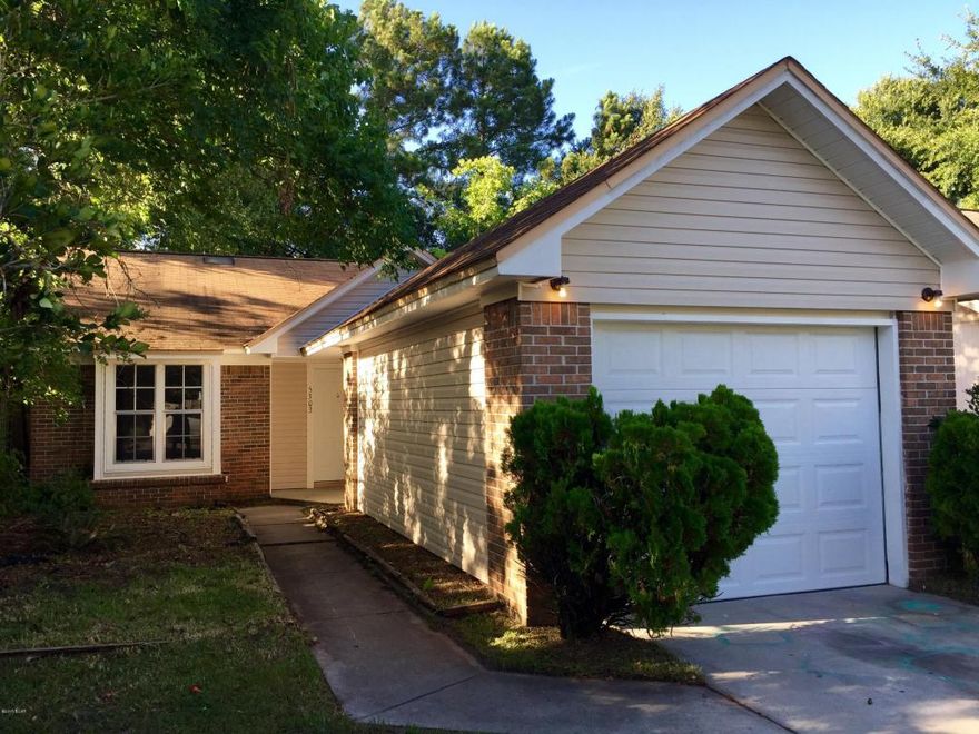 This patio style home has been completely renovated on the interior with new paint throughout, new kitchen cabinets and a stainless appliance package, and new up to date flooring throughout!  The kitchen has been completely updated with granite counters, stainless appliances and a beautiful modern tile on the floors. There is a dishwasher, a side by side refrigerator with icemaker, solid surface stove; digital and self cleaning. Subway white tiles on the backsplash add just the perfect touch along with the black sink and new faucet.  All wet areas are updated tile and the great room is hardwood laminate.  There is new carpet in the bedrooms and all walls have just been painted as well! The bathrooms are sporting new modern vanities and tub / shower combinations.  Parking and the laundry