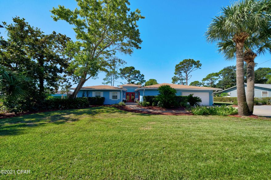 100 waterfront feet on North Lagoon in Panama City Beach! One story home on lagoon featuring 4 bedrooms, 3 full baths, gorgeous kitchen, large laundry room, office, Florida room; complete with pool, 1/2 acre yard, and dock. This well cared for home is solid with stucco over concrete block, and boasts hardwood floors, granite countertops, waterfront master that steps out to a private deck, and spacious living room with gas fireplace. Enjoy watching nature in your backyard resort with pool, patio area, green space and dock - all with lagoon views!  Backyard is fenced in, has a convenient side double gate entry, and shed with power.  2 car garage and ample driveway parking.   Private office with it's own entrance, perfect for a home business. NO HOA! Call today for your new waterfront home!