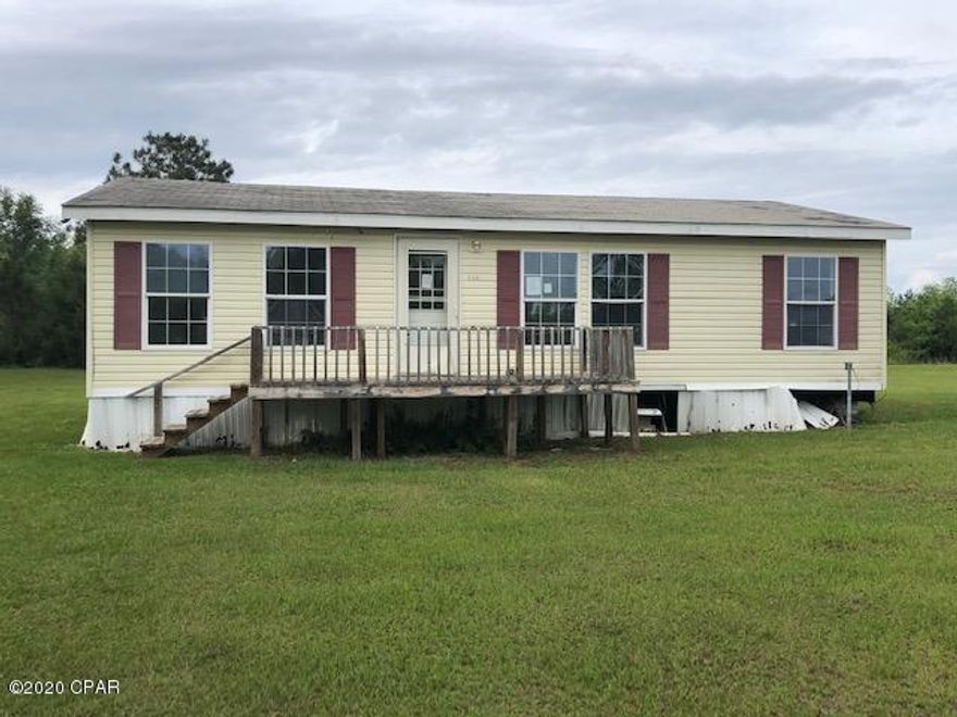 * PRICE REDUCED * Great opportunity to own your own home in the country on a large acre lot.  This doublewide mobile home needs some repairs and updates but will be a great  investment for you.   There is a formal living room, an eat-in kitchen, 3 bedrooms 2 baths and a laundry room.   There is an open front and back porch.   You have room for  a garden here and/or a few pets to enjoy in this country setting.