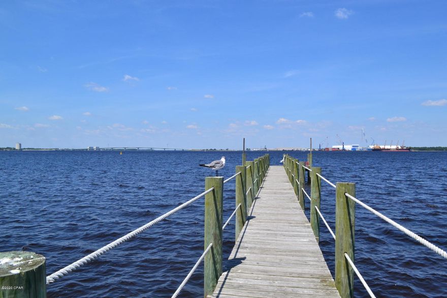 Stunning waterfront town home, This Pelican Bay town home was built by Tom Ledman, This home withstood Hurricane Michael and this owner was the only resident to be able to continue to live in her home after the storm. This one owner home has been well cared for over the years, After the storm the home got a new screen porch, new roof and new sofits and fascia, this home is water front with Incredible views of the Bay and the Hathaway Bridge. This home comes with an open floor plan, 3 spacious bedrooms and 2.5 baths, has ample storage space and has been freshly painted. The owner of this home has never owned a dog, never smoked, and home is in immaculate shape. Home has corian counter tops, new dishwasher, new refrigerator, This neighborhood has club house, pool, dock, you can park your Home has corian counter tops, new dishwasher, new refrigerator, This neighborhood you can park your boat behind your house in the bay, This home has so much to offer and has magnificent views of St. Andrews Bay.