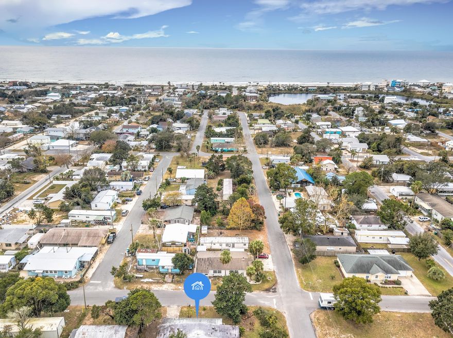 GREAT OPPORTUNITY for a primary or secondary home on the West End of Panama City Beach in LAGUNA BEACH! Only 0.4 mile (a short golf cart ride, bike ride or walk) to the beautiful white sandy beaches of Panama City Beach and emerald green waters of the Gulf of Mexico, a short drive to 30A, Pier Park, dining, shopping and the airport. This 2/2 mobile home is located South of Hwy 98 on a nice, large 60x100 corner lot with plenty of space for RV and Boat parking, covered carport and NO HOA fees! This home boasts a screened in front porch, covered back porch and a large 20x12 yard building that can be used as a workshop. Verify measurements if important.