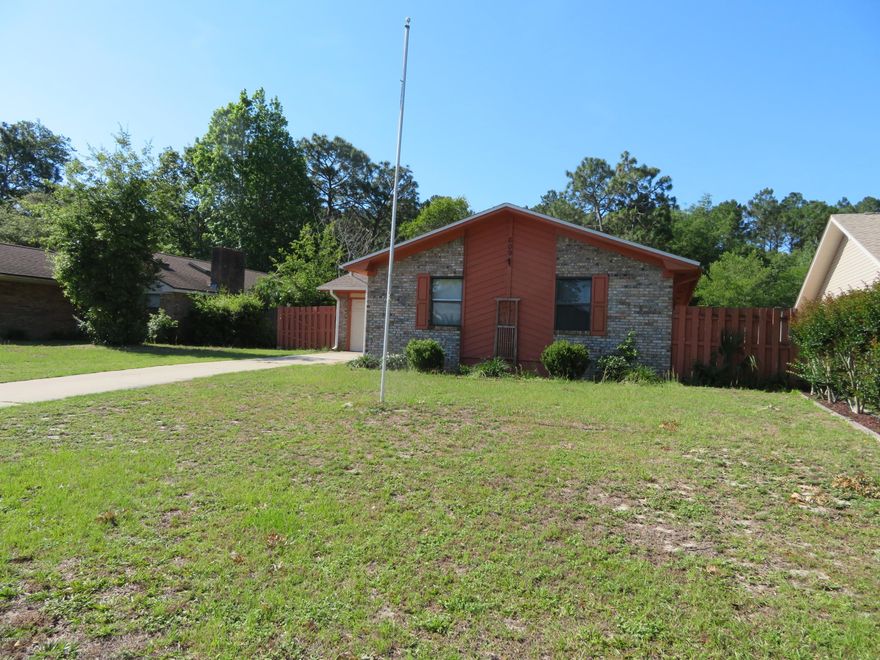 Perfect starter home or investment property!  This 3 bedroom 2 bathroom brick home is located in Lynn Haven convenient to Panama City or the beaches.  The home enters to an open living & dining area with sliding glass doors that lead to the fenced backyard. The master bedroom offers a walk in closet and private bathroom.  Guys will love the garage with a parking area and a separate workshop/storage area. All it needs is a little paint and small fixes to make it feel like home.  It is affordably priced and won't last long.