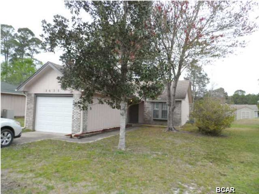 Hard to find LYNN HAVEN AREA HOME that's move in ready and AFFORDABLE! Rural Development Financing can open the door for many buyers and this home is MOVE IN READY. The large lot creates ''COUNTRY FEEL'' but you're only minutes to GREAT SCHOOLS and all the shopping in the Lynn Haven Area. Tyndall AFB and the Navy Base are both quick drives for an easy commute. This Open Floor Plan creates a spacious feel with HIGH CEILINGS and the Living , Dining and Kitchen areas all flowing together. The Master Bedroom is split for privacy and features a private bath. Sliding Glass Doors Open the Family Room up to Covered Porch and a very large partially fenced back yard. The Kitchen includes a new stove and dishwasher. A very functional eating area connects the kitchen with the garage. Don't miss