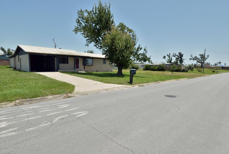 Spacious home, large master bedroom that will fit your king bed, hardwood laminate floors, carport,and a open back yard. The is a second room with a half bath. This home has a split living plan layout.  Best part is the view of the lake! So Picture yourself sipping your morning coffee on your front porch that overlooks Lake Martin. Does that not like a dream?