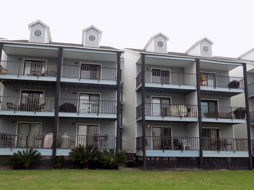 Cute condo with upgraded cabinets, light fixtures, and beautiful tile floors. The unit is one bedroom, one bath with a loft that could be used as a bedroom or home office. Nice deck with views of Grand Lagoon! Age, Square Footage, and Room Size are approximate, please verify.