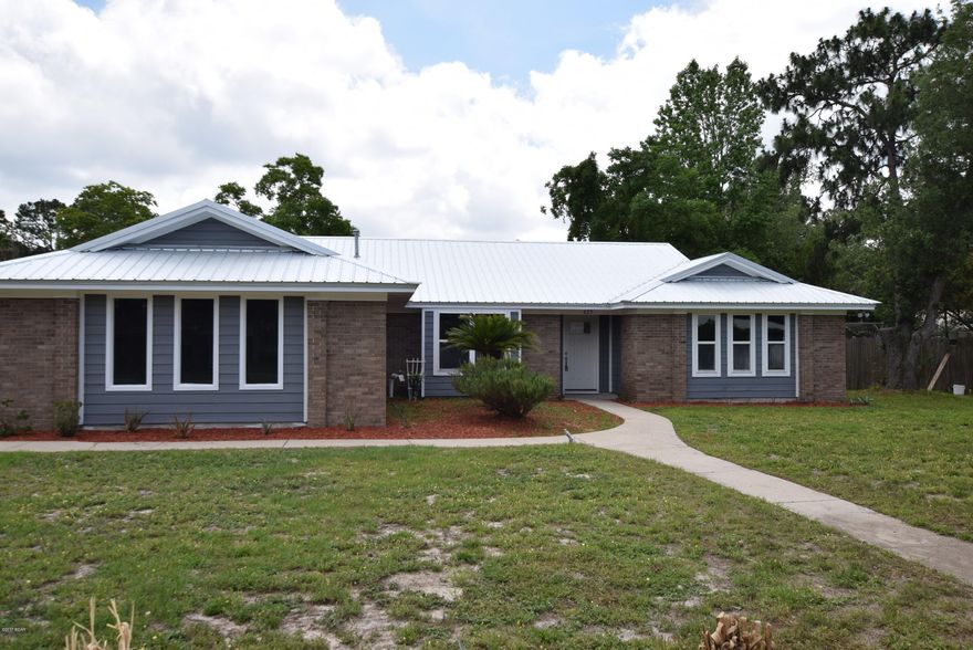 Complete renovation!! This home has undergone a complete renovation in 2017.  New 50 year metal roof.  New HVAC, water heater, paint, flooring, fixtures, fencing, doors, garage door, and appliances. This is a new house!  Granite counters in the kitchen and bathrooms.  Large bedrooms.  Laminate flooring throughout the entire home. Vaulted ceiling in the Family Room with a real wood burning fireplace. Large corner lot located just minutes from Tyndall Air Force Base, shopping, restaurants, and beaches.  This house is priced to sell, make your appointment today!