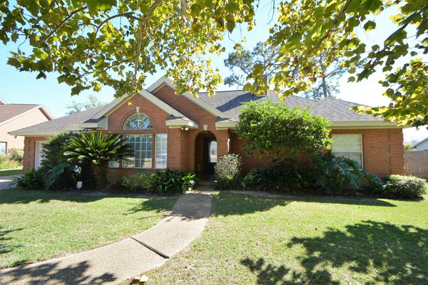 Fantastic all-brick home in the popular Woods subdivision. You will immediately notice the open floor plan as you enter the home with the formal dining room on the left and the spacious family room ahead. The dining room has a vaulted ceiling and the family room features a fireplace and French doors to the rear lanai. The kitchen boasts loads of counter space and cabinets. The large master bedroom is one one side of the home away from the other bedrooms and has doors to the lanai as well. The master bath has a whirlpool tub, separate shower, double vanities and a walk-in closet. The additional bedrooms are nice-sized and share a Jack & Jill bath. The back yard is very big, fully fenced and has a covered patio.  This is a super home, well maintained and convenient to everything!