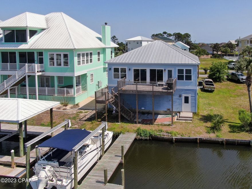 CURRENTLY UNDER CONTRACT, SELLER WILL CONSIDER BACKUP OFFERS. Waterfront living is calling your name! Custom built home with 50ft of canal waterfront and private boat dock and lift. Be in the gulf in just a few minutes. Open concept living, all on the second floor. Ground floor is finished, two car garage for all of your storage needs. Short term rentals are allowed in this area. Call today!