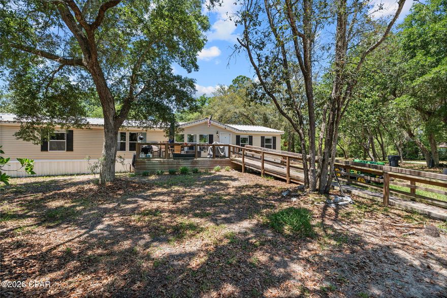 Situated on 2.5 expansive acres in desirable Southport, 8325 Resota Beach Dr offers endless potential with plenty of room to create your ideal homestead, investment property, or private retreat. This large 4-bedroom home also features valuable flex space perfect for a home office, playroom, guest area, or additional living space to fit your needs. The backyard features a 32x48 Pole barn with attached room and has electric & water already connected! With spacious interiors and a prime location near boat ramps, shopping, dining, and Panama City amenities, this property combines privacy with convenience. The bathroom has been gutted and is ready to be completed to your personal style, offering a great opportunity to add value and customize. With acreage, size, and versatility, this property is packed with possibilities for the right buyer.
