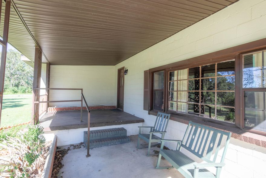 Great four bedroom conveniently located, and on a paved road!  Living has tongue and groove walls and hardwood floors.  There is also a gas fireplace in the living room.  Yard features an outbuilding.